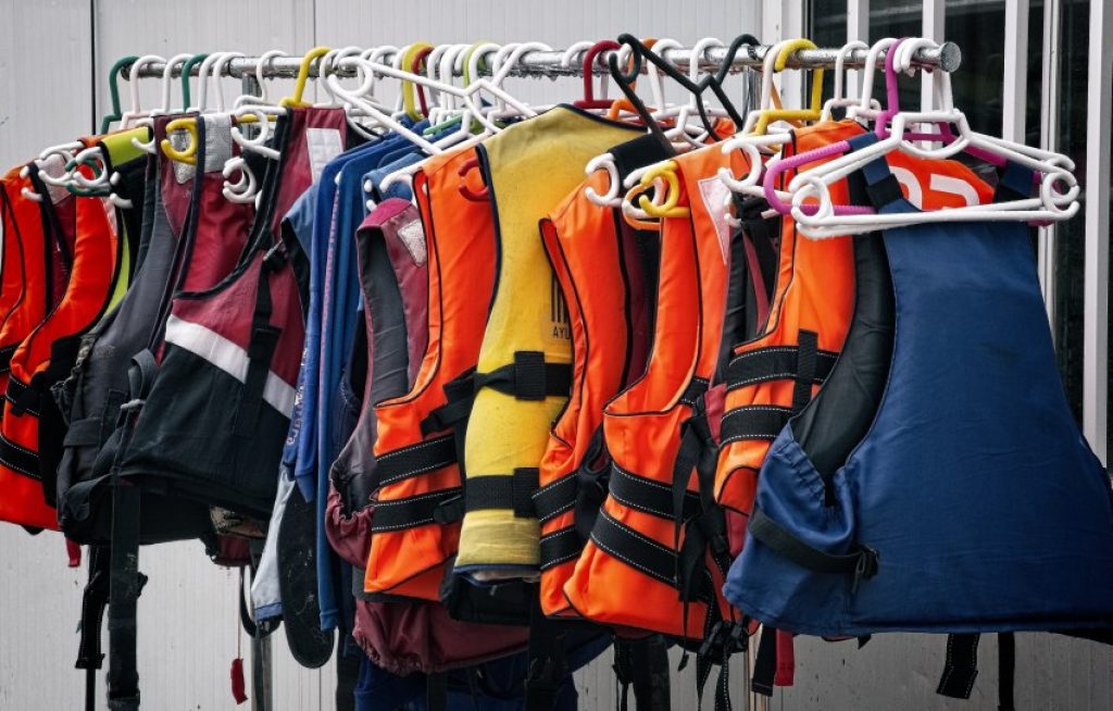 PFDs of different colors hanging on a rail