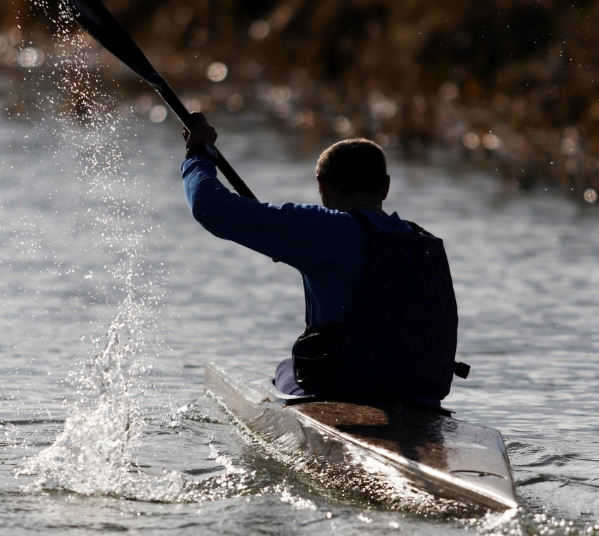 Paddler's shadow figure on the water