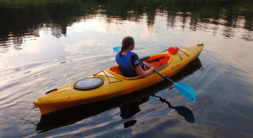 A female kayaker in a sit-inside kayak