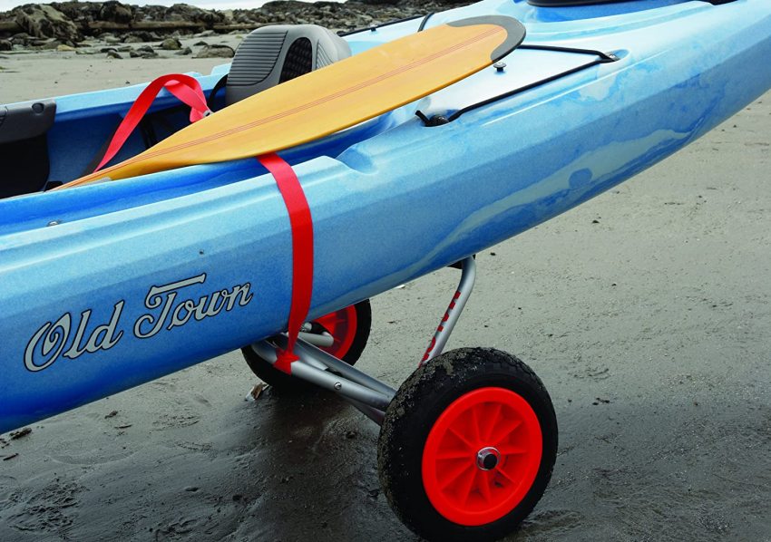 A blue kayak and a yellow paddle on a metal cart with black and red wheels