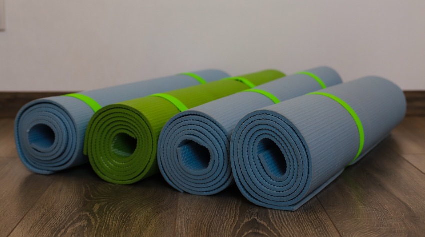 Four rolled up gym mats on the floor