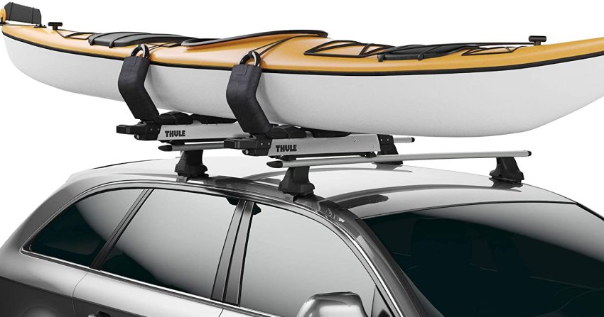 A white-yellow kayak resting on two load assist racks on the car roof