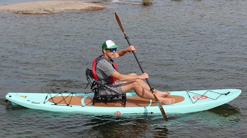 A man paddles his turquoise-colored SUP hybrid kayak