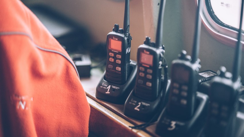 A set of black walkie-talkies inside the vessel's cabin
