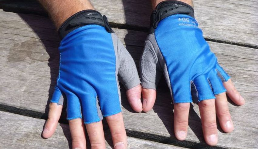 Two human hands in blue/grey fingerless gloves