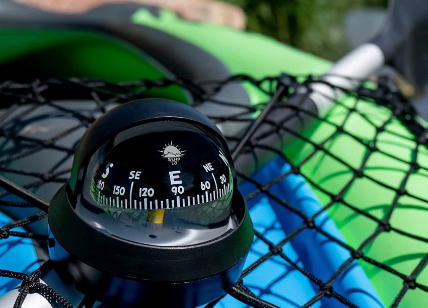 A black marine compass on a kayak