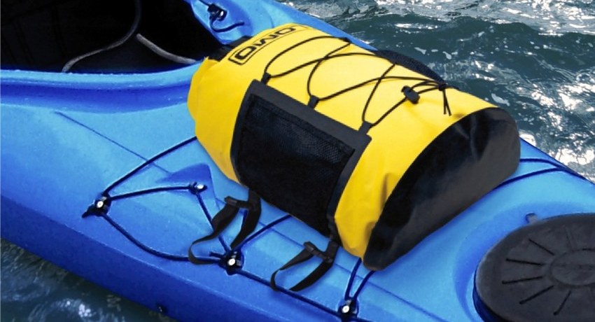 A yellow dry bag attached to a blue kayak hull