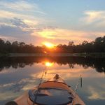 Bow of a kayak and sunset