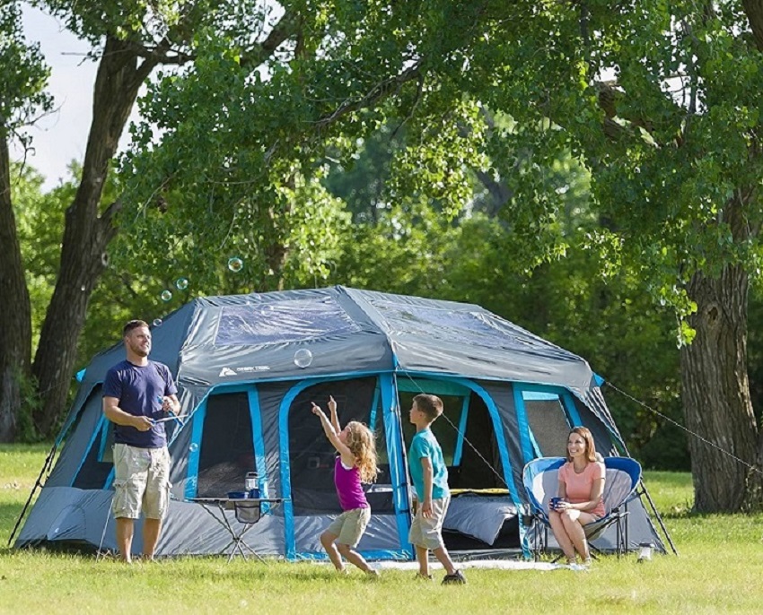 A family plays outside the Ozark Trail Camping tent