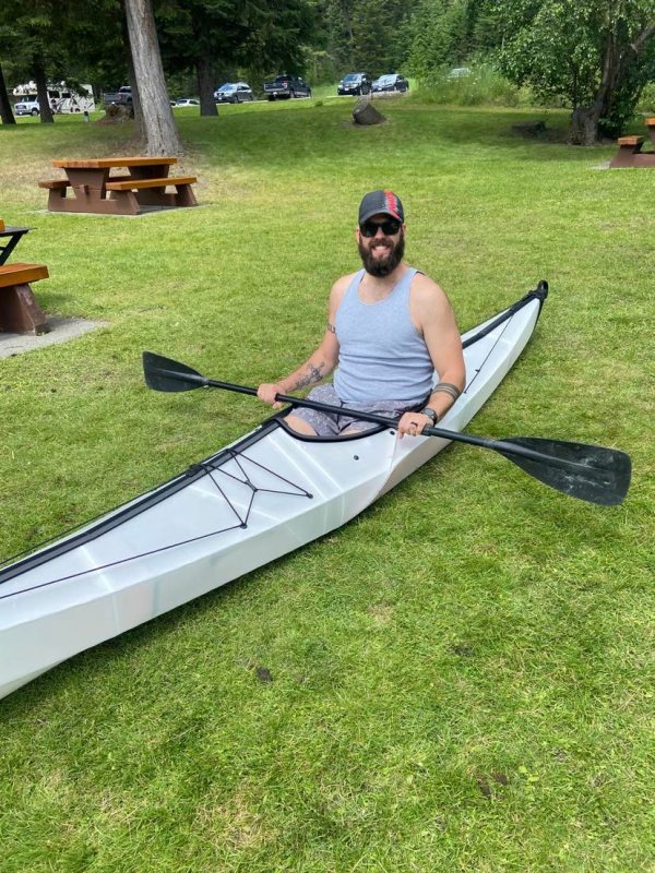 Author sits in fully assembled ORU Bay ST kayak and holds a paddle