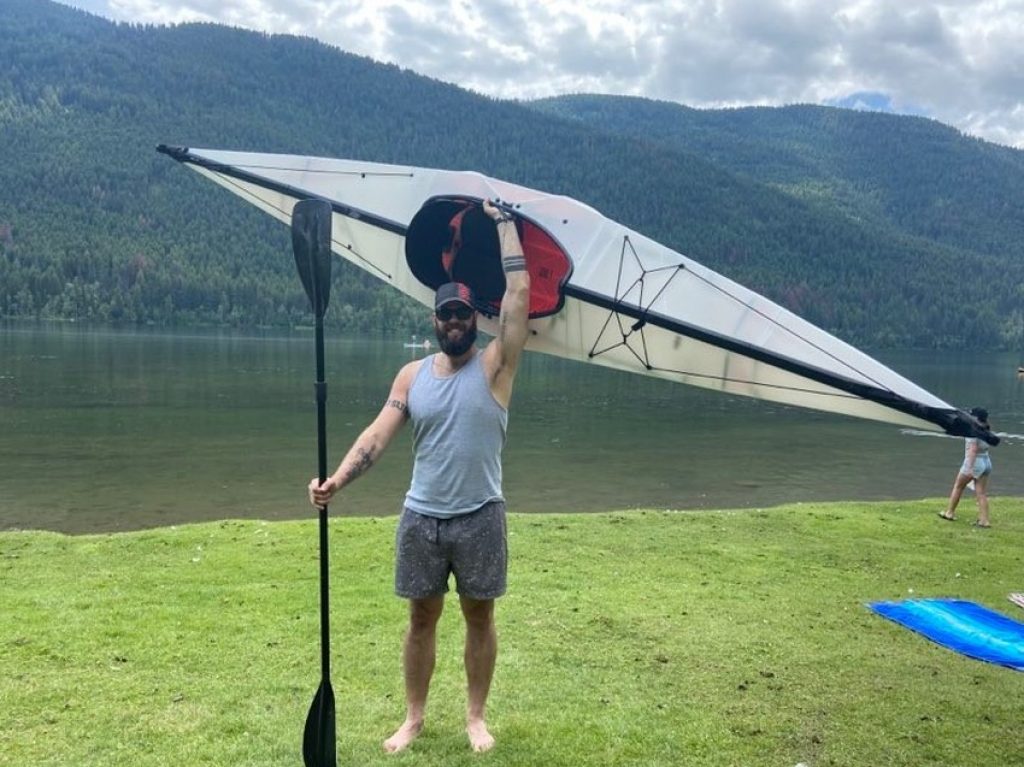 Author holds assembled ORU Bay ST kayak and a paddle