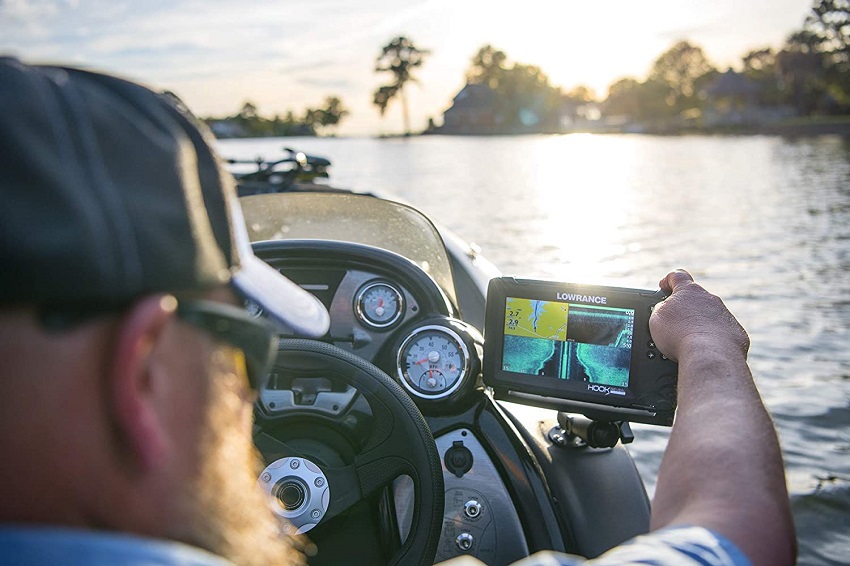A man reads data from the Lowrance onboard GPS device