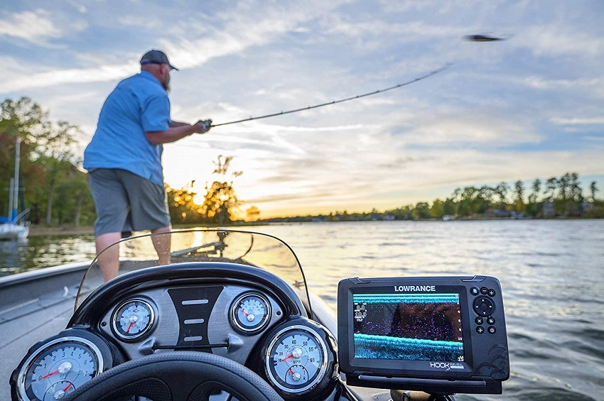A man fishes from the bow of a vessel, equipped with Lowrance GPS device