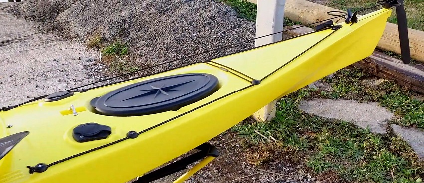 Two flush-mounted rod holders with covers and a large, oval storage waterproof hatch on the BKC SK287 kayak