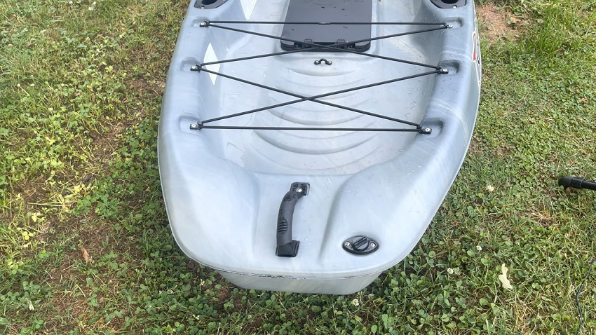 A rear rubber-lined carrying handle and a drain plug of the Sun Dolphin Boss 12 SS kayak