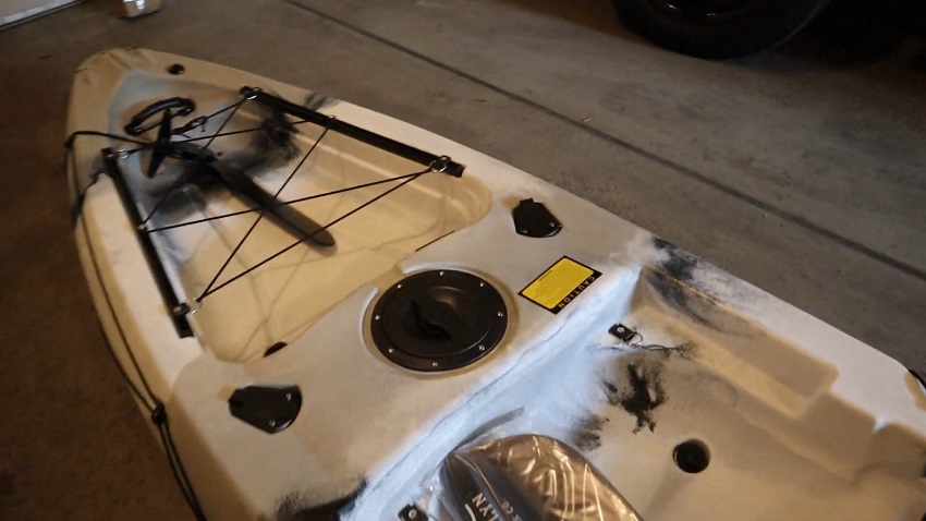 A waterproof compartment and twin rod holders, covered with lids, and a large storage with a traditional bungee cord system towards the stern of a BKC FK13 kayak