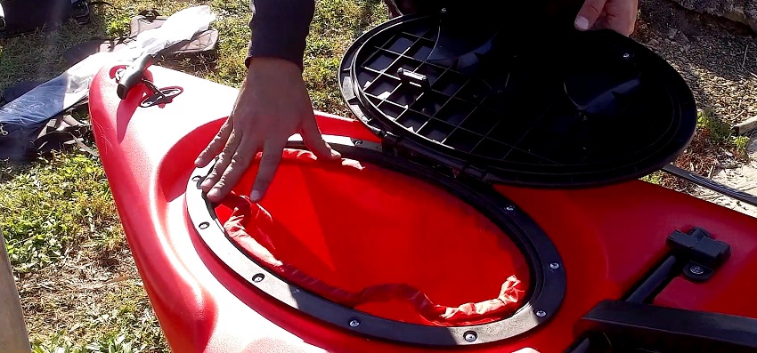 A t-handle and a drain plug, a waterproof, oval storage through-hull hatch with an insert dry bag on the BKC PK12 kayak