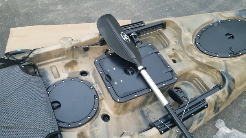 A rectangle through-hull hatch with a dry bag, a round hatch with another dry bag, and a paddle of the BKC RA220 kayak