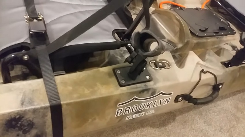 A carry handle with paddle park system and a rod holder on the BKC TK122 kayak