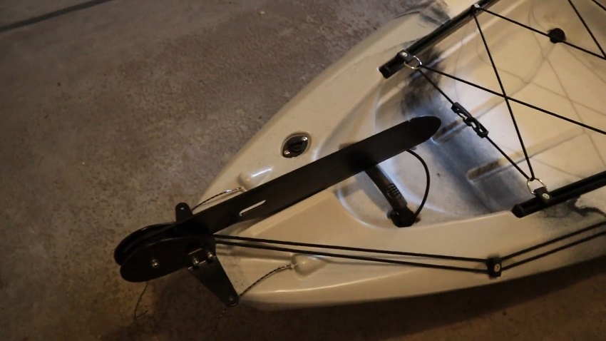 A foot-controlled rudder system, attached to the BKC FK13 kayak with a pin