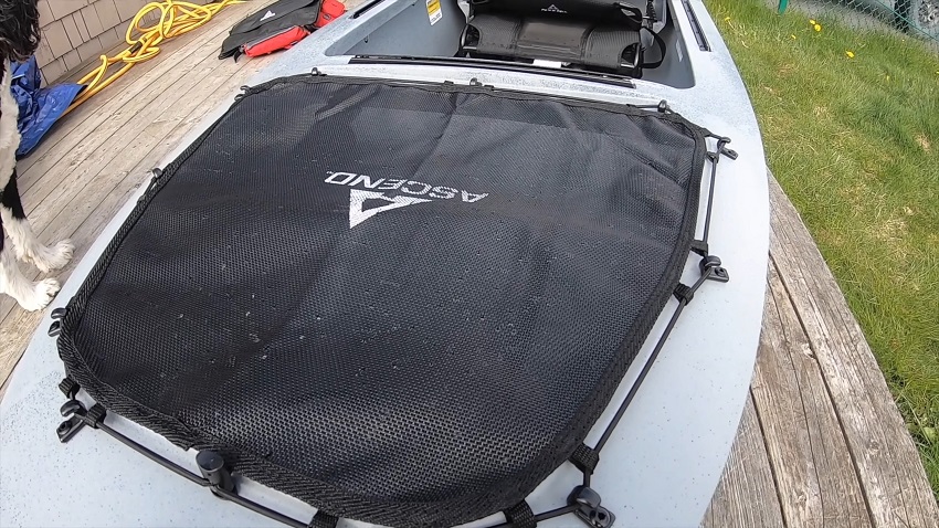 Bow storage compartments covered by cargo mesh and bungee cords on J-hooks