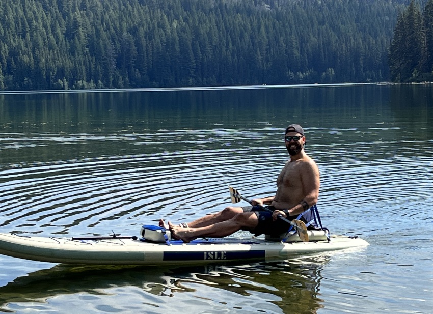 A man paddles the Isle Switch 2 in 1 Inflatable Kayak & Paddle Board