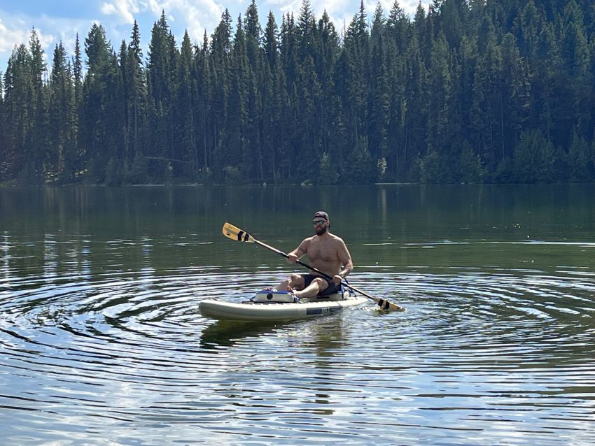 Author paddles the Isle Switch 2 in 1 Inflatable Kayak & Paddle Board, while sitting on it