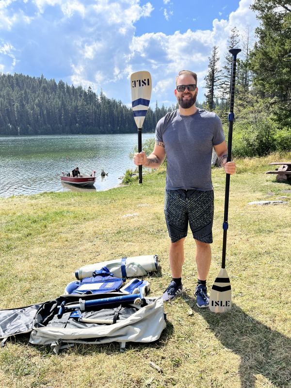 Author holds two paddle components of the Isle Switch 2 in 1 Inflatable Kayak & Paddle Board