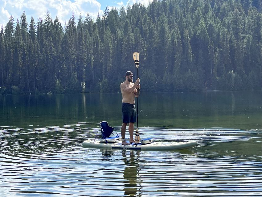 Author stands on the Isle Switch 2 in 1 Inflatable Kayak & Paddle Board on water
