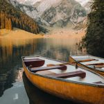 Two yellow canoes are parked on a beautiful mountain lake