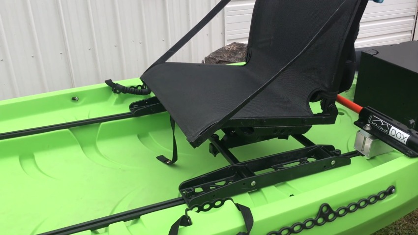 A black seat on a green kayak