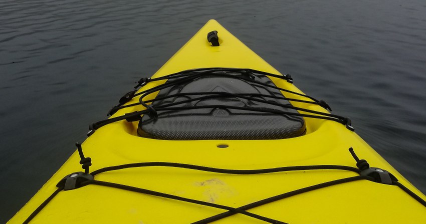 A black bow hatch on a yellow kayak