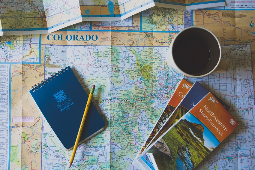Colorado map, notebook with a pencil and a cup of coffee