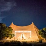 A canvas tent with lights outside