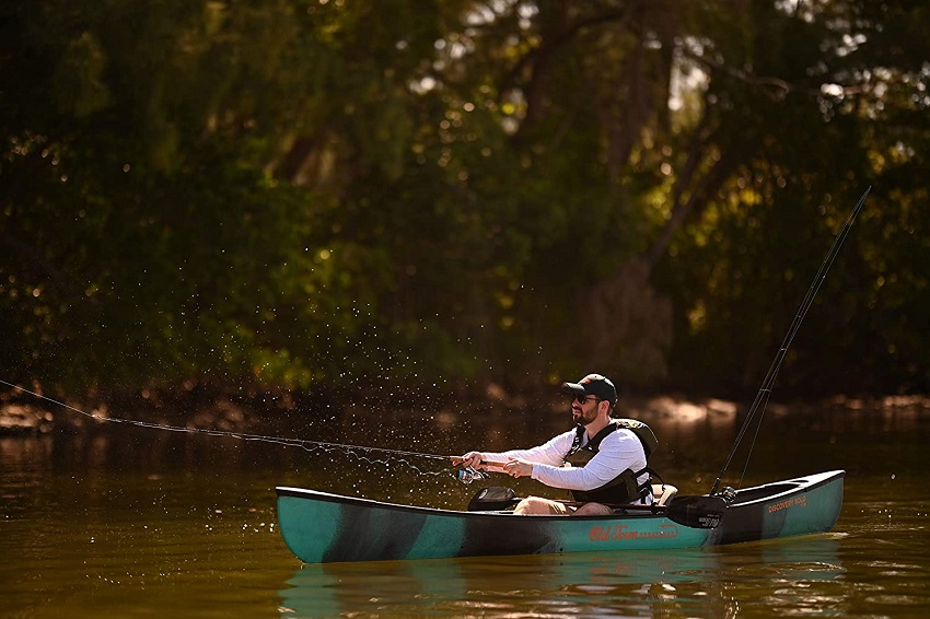 An angler casts a line from the Old Town Sportsman Discovery Solo 119 fishing canoe