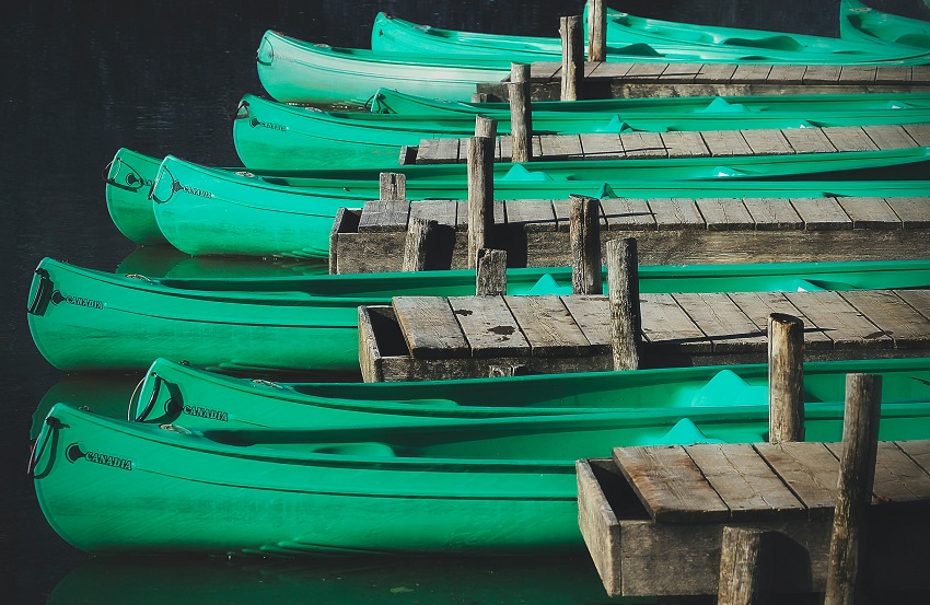 Ten green plastic canoes