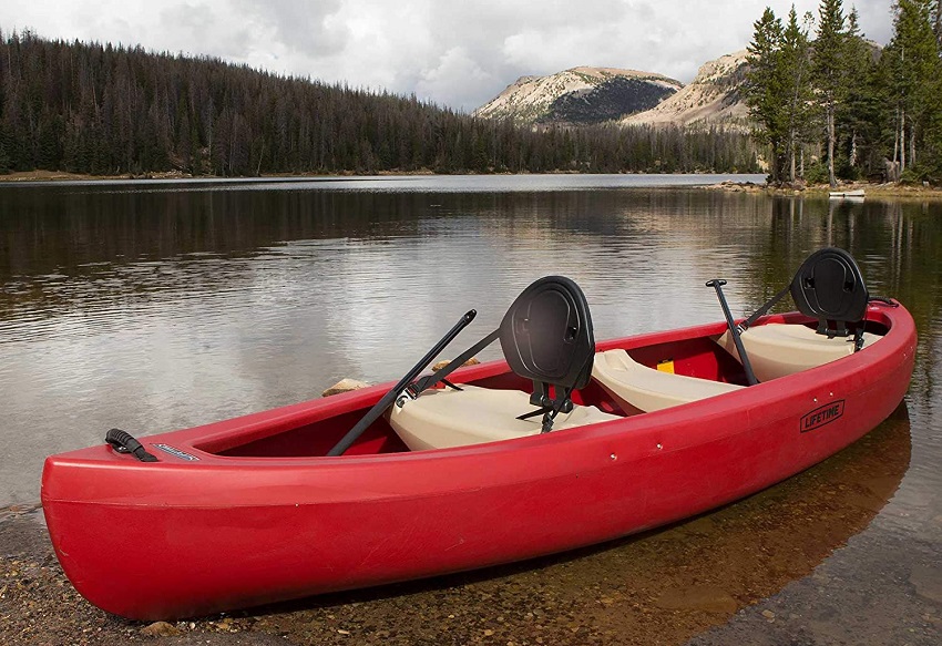 The red Lifetime Kodiak two-seat canoe  on a lake shore