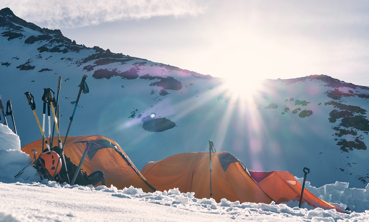 A campsite, surrounded by snowy mountains