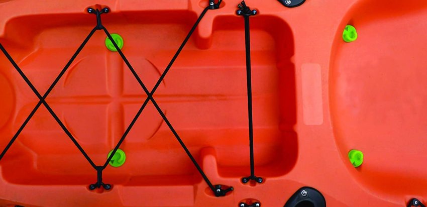 Four green scupper plugs in a red plastic kayak