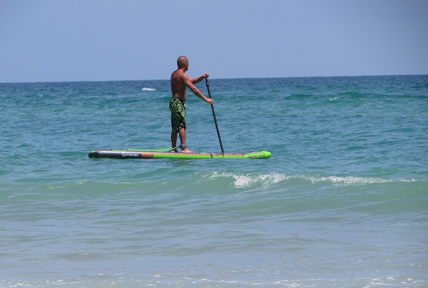 A man paddles his SUP at sea
