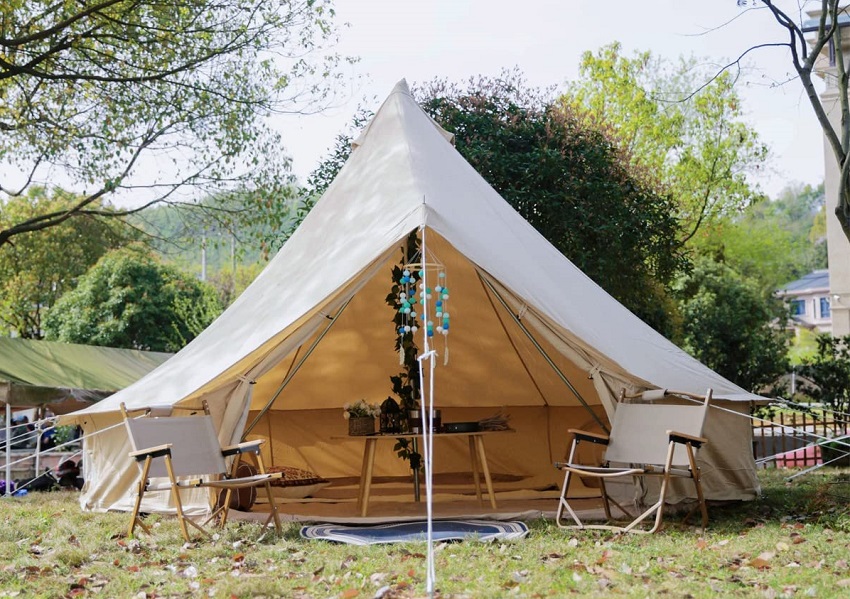 Yurtent Roomy Bell Tent with open doors and two camping chairs outside