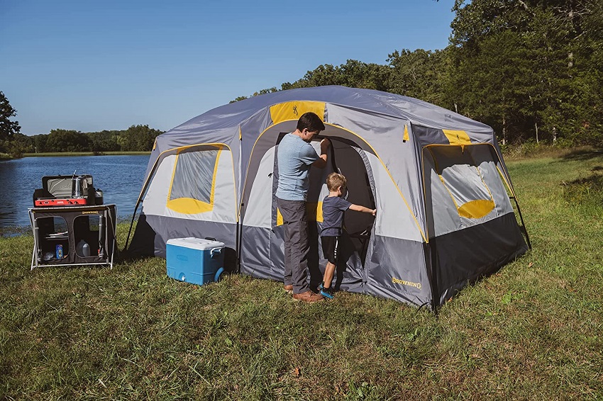 A man and a boy enter the Browning Camping Big Horn Tent, pitched outdoors