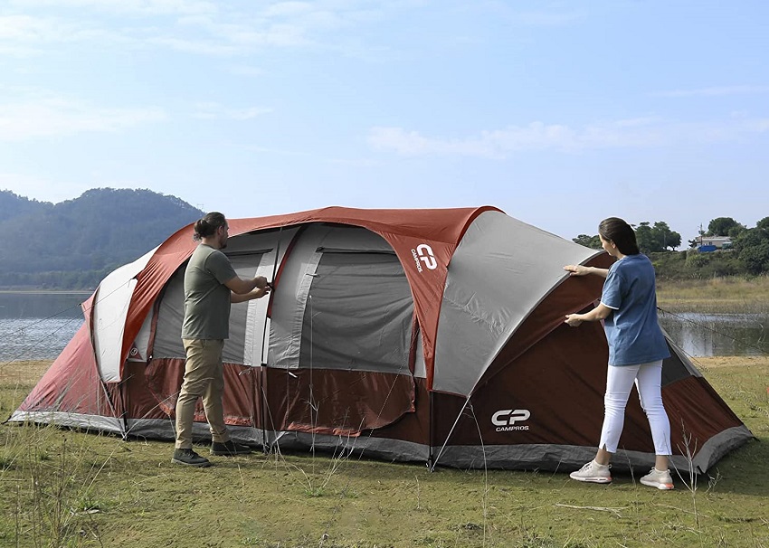 A man and a woman pitch the Campros CP Tent outdoors