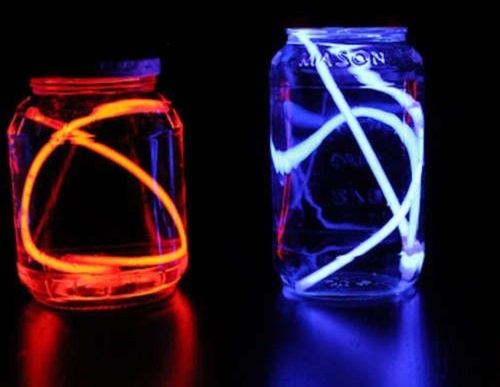 Two glow sticks inside glass jars