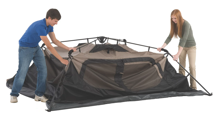 A man and a woman set up the Coleman 6-Person Instant Cabin Tent