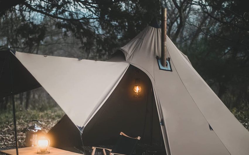 A tent with a stove jack pitched in the woods