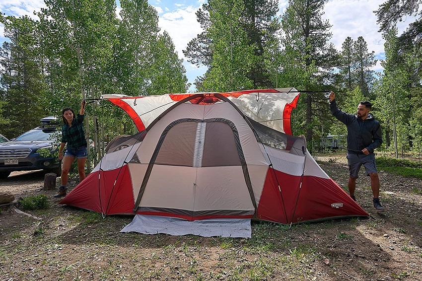 A man and a woman set up the Wenzel Bristlecone 8-Person Dome Tent