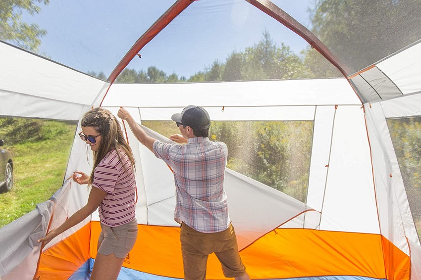 A man and a woman set up the Eureka Copper Canyon LX 6 Person Tent