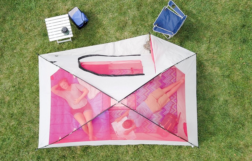 A woman and a man relax inside the Ozark Trail 6-Person Dome Outdoor Camping tent