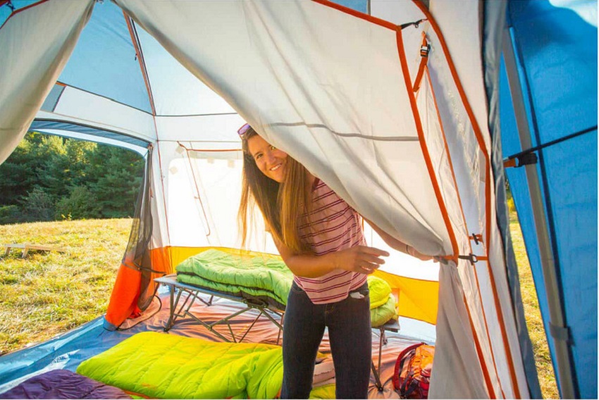 A girl stands inside the Eureka Copper Canyon LX 8 Person Tent